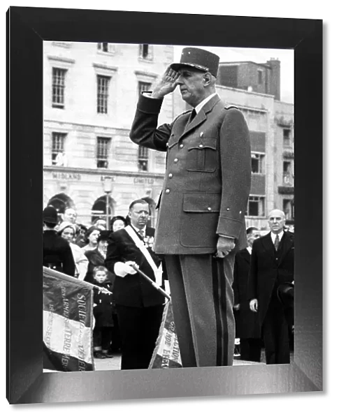 President Charles De Gaulle - salutes in front of the Marshall Foch statue in