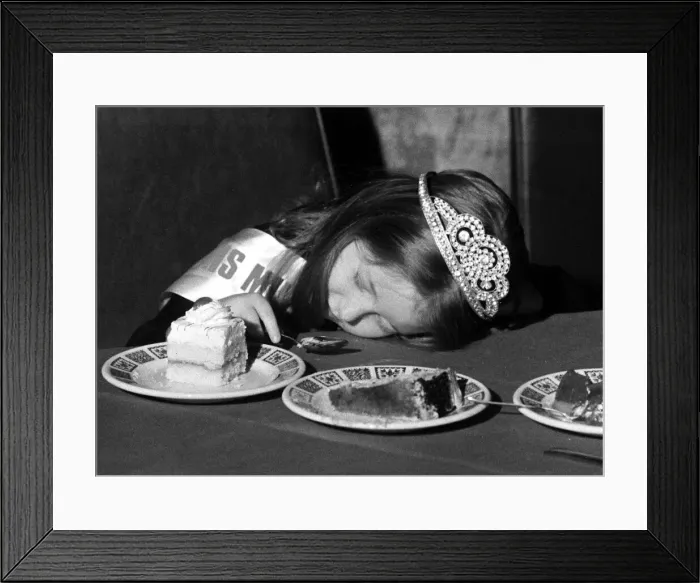 Framed Print : A young girl fall asleep on the table whilst eating a peice of cake - Childrens