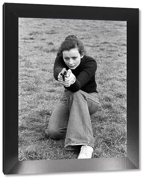 Chief Instructor, Sergeant Ivor Montgomery, training police women on the firing range at