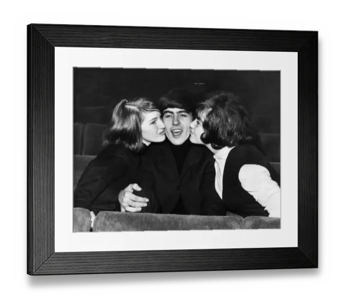 Framed Print : George Harrison of The Beatles is kissed by two female fans Framed Print : George Harrison of The Beatles is kissed by two female fans