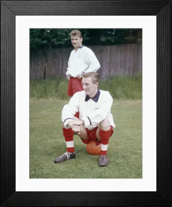 Framed Print : England football team training. George Eastham sitting down, watched by Roger Hunt Framed Print : England football team training. George Eastham sitting down, watched by Roger Hunt
