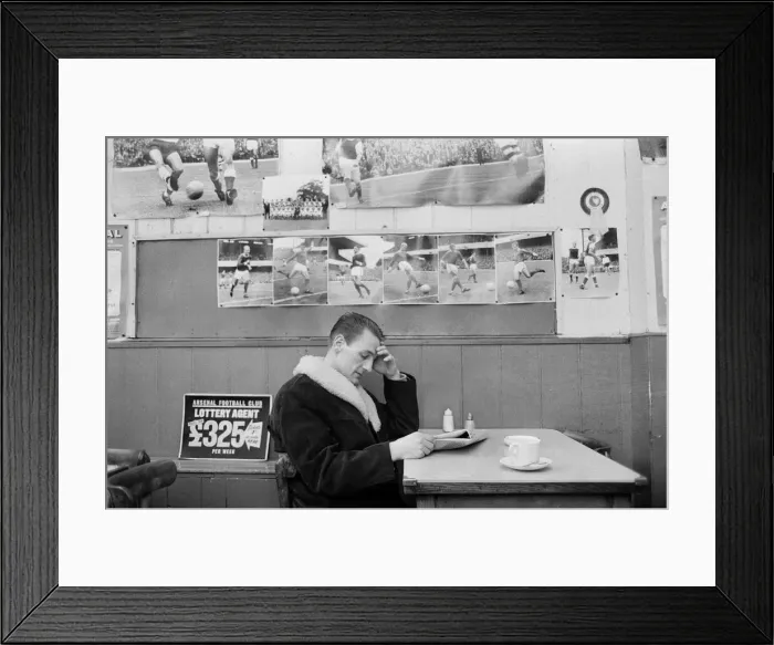 Framed Print : Arsenal inside forward George Eastham sits with a cup of tea in a cafe near his club Framed Print : Arsenal inside forward George Eastham sits with a cup of tea in a cafe near his club