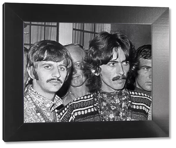 Ringo Starr (left) and George Harrison (right) of The Beatles face the press on the news