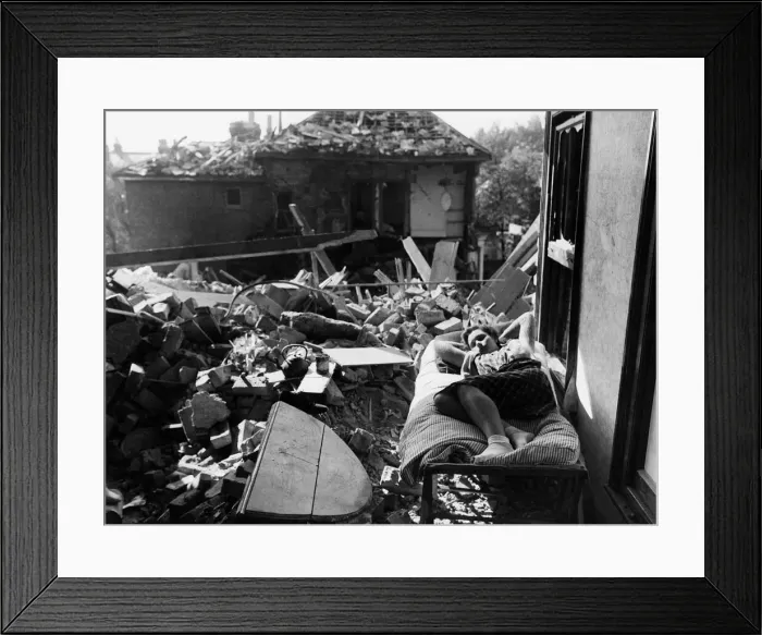 Framed Print : Miss D Hubert age 16 having delved among the wreckage of the top flat, takes a rest Framed Print : Miss D Hubert age 16 having delved among the wreckage of the top flat, takes a rest