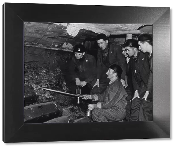 An instructor at the Government pit school showing Bevin Boys how to follow a seam of