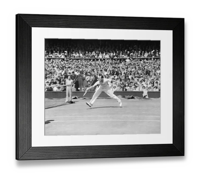 Framed Print : Fred Perry (GB) plays a back hand shot at the net, competing at Wimbledon Tennis in
