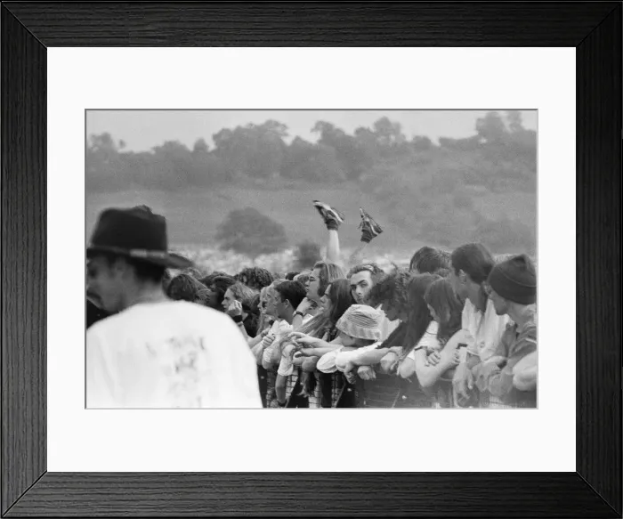 Framed Print : Glastonbury Festival 1994. General scenes of the crowd with a pair of legs Framed Print : Glastonbury Festival 1994. General scenes of the crowd with a pair of legs