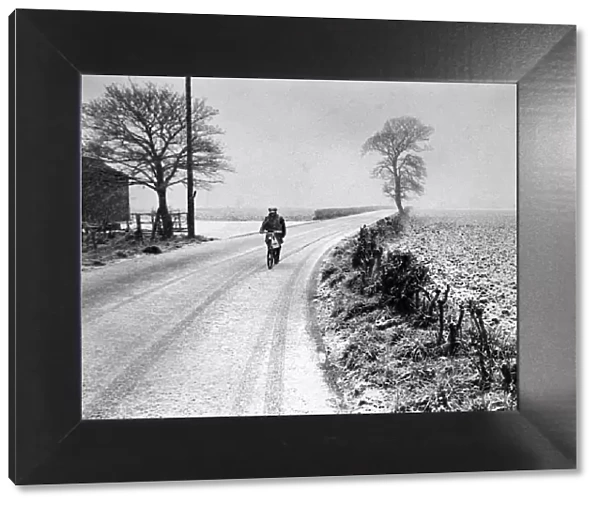 A lone cyclist pedals through the blizzard at Aughton, Lancashire. 26th March 1975