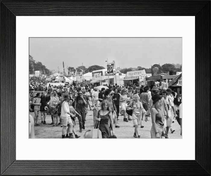 Framed Print : Glastonbury Festival 1994. General scenes. Festival goers walk besides Framed Print : Glastonbury Festival 1994. General scenes. Festival goers walk besides