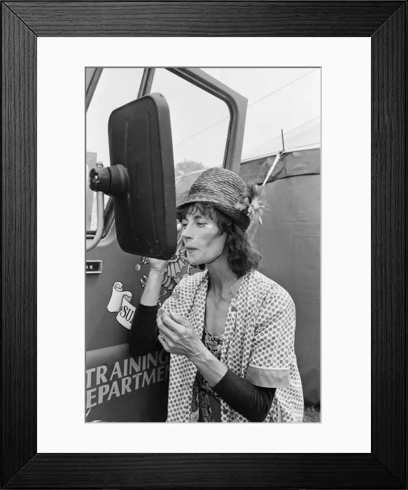 Framed Print : Glastonbury Festival 1994. General scenes. A festival entertainer adjusts Framed Print : Glastonbury Festival 1994. General scenes. A festival entertainer adjusts