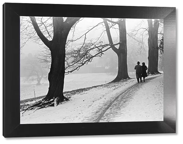 A couple walking in a snowy Regents Park London. 21st January 1942