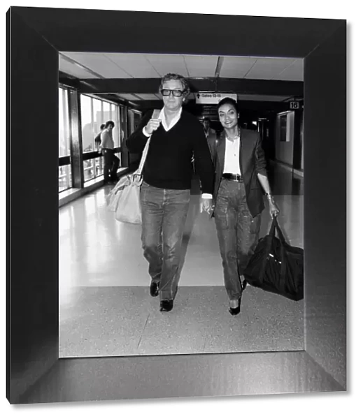 Actor Michael Caine and his wife Shakira arriving at Heathrow Airport from Barbados