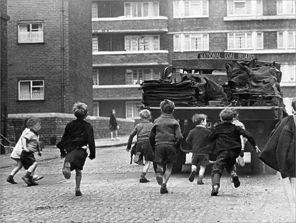 Toddlers in Merseyside running after National Coal Board Lorries and trying to jump