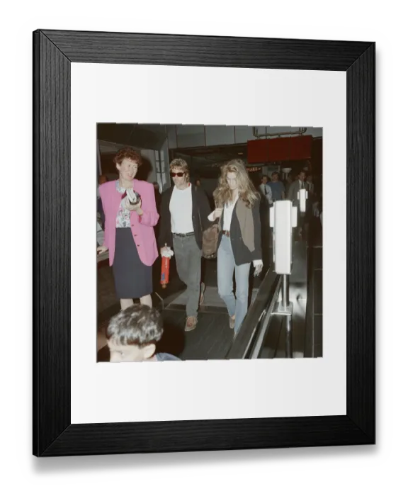 Framed Print : Cindy Crawford (model) at London Heathrow Airport. Cindy is with her husband, actor