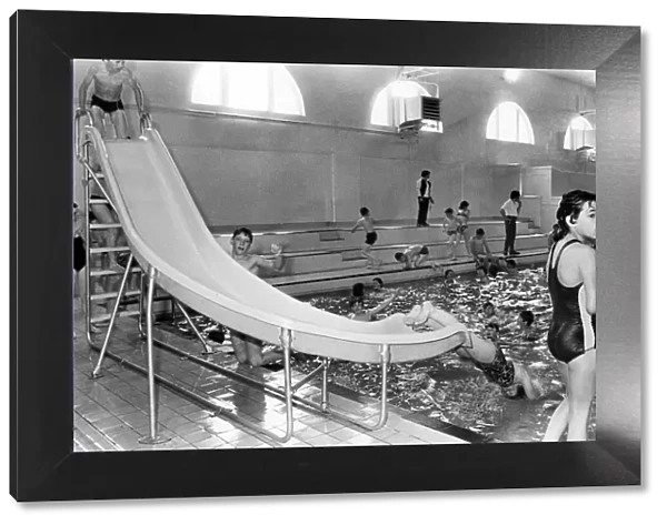 Youngsters enjoy a quick slide to swimming at the new look Wallsend baths. 28th July 1980