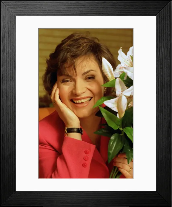 Framed Print : Lorraine KELLY next to a green white plant red jacket watch Framed Print : Lorraine KELLY next to a green white plant red jacket watch