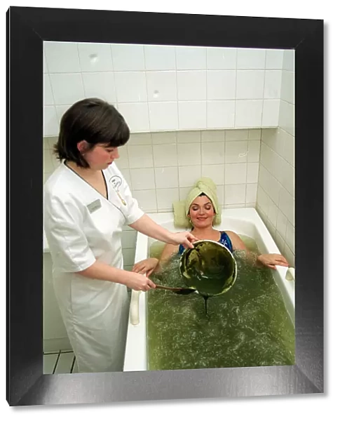 Lorraine Kelly Beauty treatment lying bath green mud being poured in