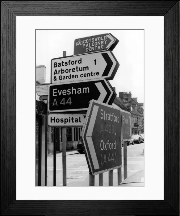 Framed Print : Every which way but Newport, a signpost in the centre of Moreton-in Marsh