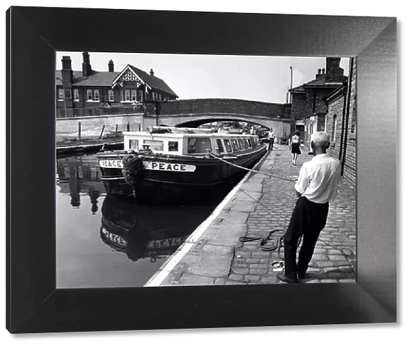 Reflections of peace, for a hardworking canal boatman as he ties up a converted holiday
