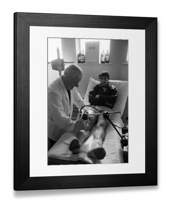 Framed Print : Manchester United training at Old Trafford. Tony Dunne having treatment on his knee ahead