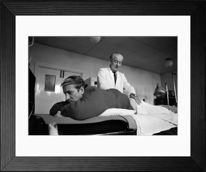 Framed Print : Manchester United training at Old Trafford. Bobby Charlton has treatment