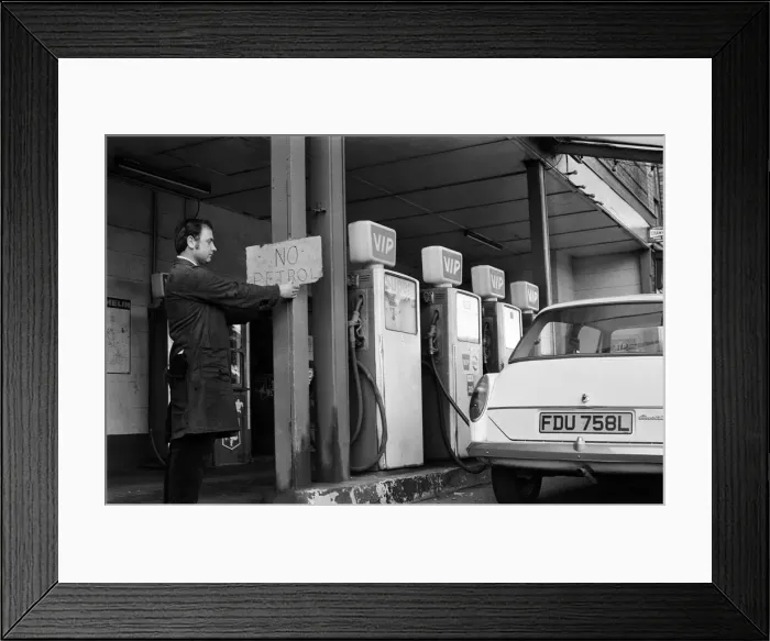 Framed Print : Mechanic Mr Keith Brodrick, putting up a No Petrol Framed Print : Mechanic Mr Keith Brodrick, putting up a No Petrol