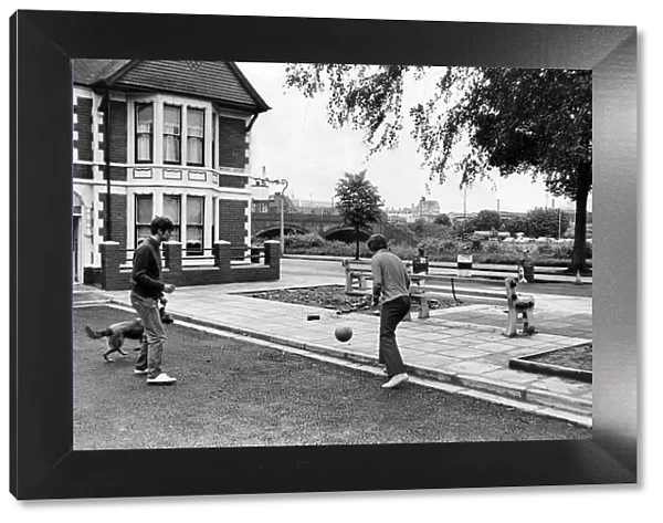 Men playing football in the streets, Grangetown, Cardiff. 14th January 1971