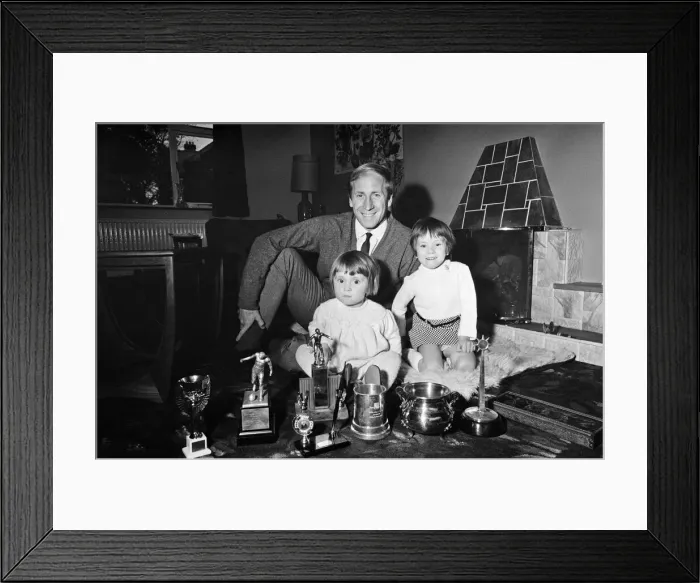 Framed Print : Manchester Uniteds Bobby Charlton shows off his many trophies that he has won to his Framed Print : Manchester Uniteds Bobby Charlton shows off his many trophies that he has won to his