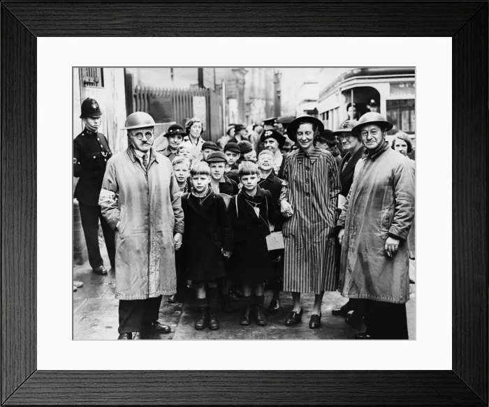 Framed Print : Wardens with tin hats hold children hands as they walk from Moor Street Station in an Framed Print : Wardens with tin hats hold children hands as they walk from Moor Street Station in an