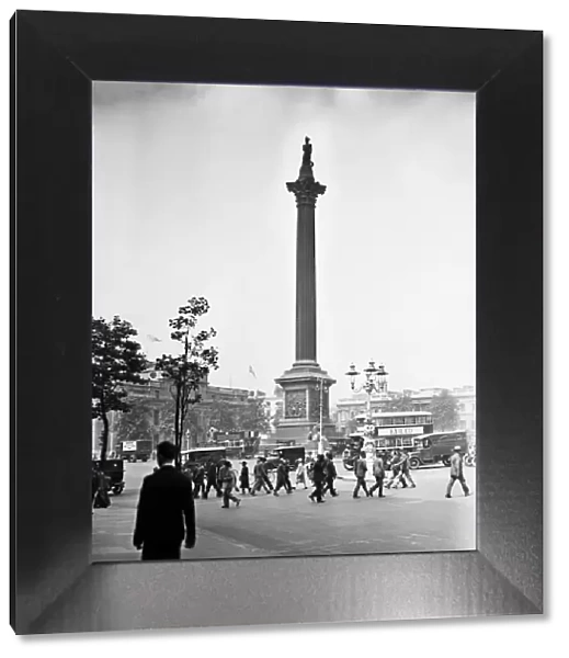 Nelsons Column, Trafalgar Square, London. Picture shows people crossing