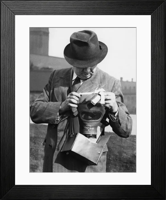 Framed Print : A member of the Sunday Mercury staff demonstrating how to put a gas mask Framed Print : A member of the Sunday Mercury staff demonstrating how to put a gas mask