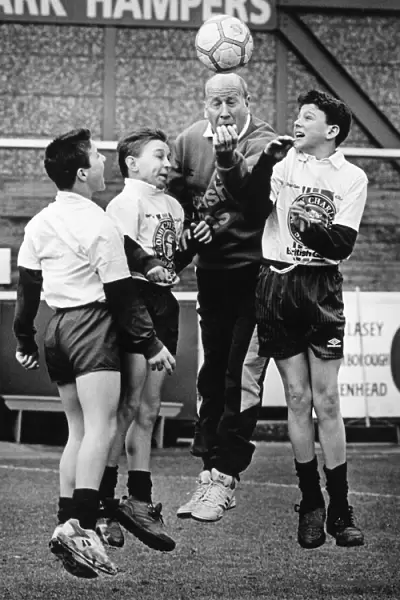 Bobby Charlton pictured training with school boys from Bebington High School