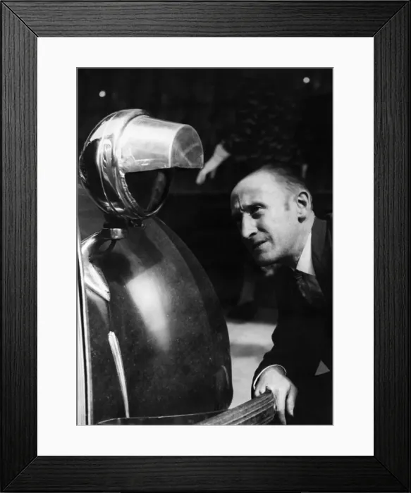 Framed Print : Motorist seen here inspecting a newly installed blackout hood on the headlights of his Framed Print : Motorist seen here inspecting a newly installed blackout hood on the headlights of his