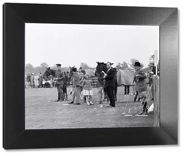 Princess Anne watches her father play polo at Windsor Great Park. 17th May 1959