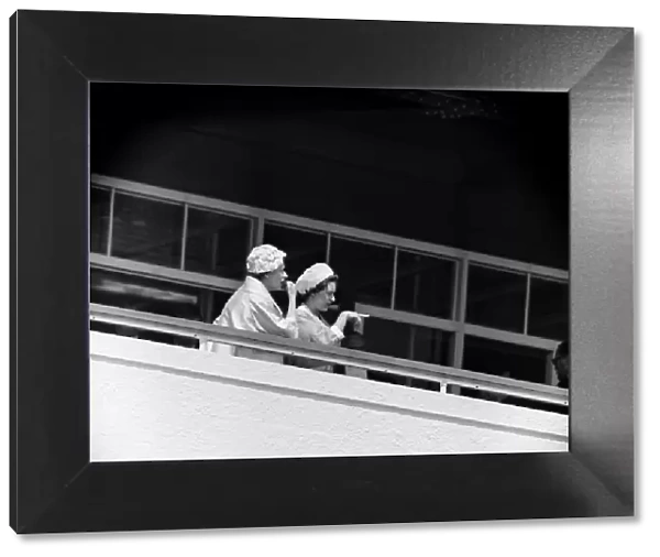 Derby Day at Epsom. Pictured, Queen Elizabeth II and Princess Margaret watching a race