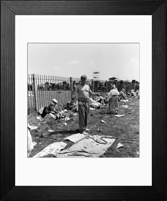 Framed Print : Derby Day at Epsom. Pictured, a strong man prepares to wrap himself in chains Framed Print : Derby Day at Epsom. Pictured, a strong man prepares to wrap himself in chains
