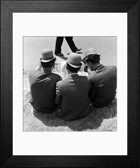Framed Print : Derby Day at Epsom. Pictured, three lads from Newmarket sitting on the grass studying Framed Print : Derby Day at Epsom. Pictured, three lads from Newmarket sitting on the grass studying
