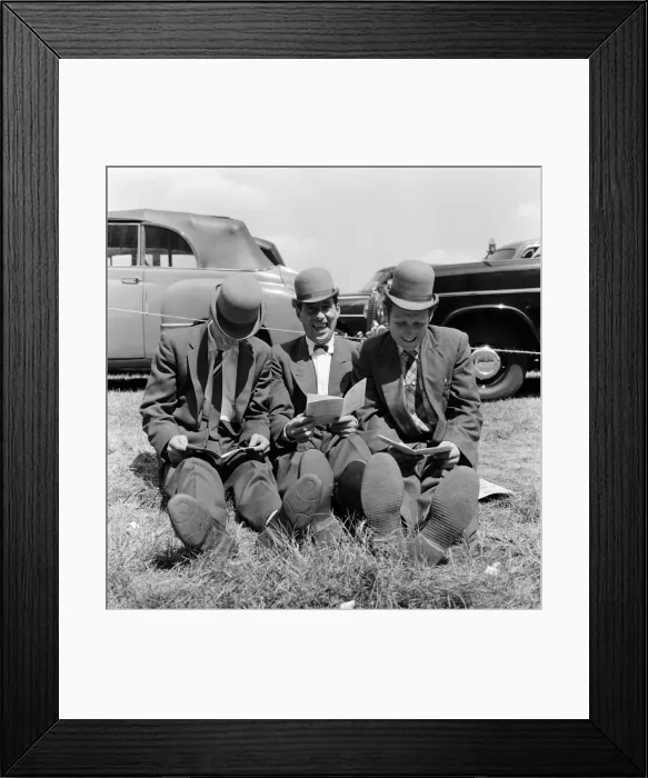 Framed Print : Derby Day at Epsom. Pictured, three lads from Newmarket sitting on the grass studying Framed Print : Derby Day at Epsom. Pictured, three lads from Newmarket sitting on the grass studying