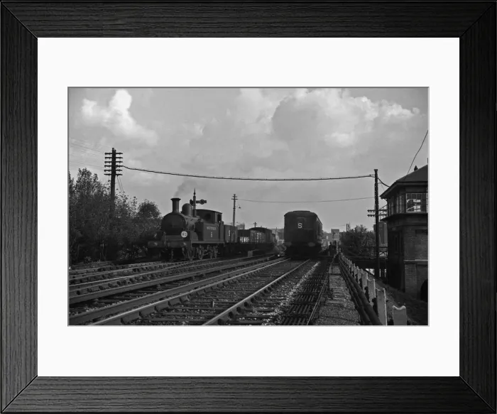 Framed Print : Southern Railways goods train passes a three carriage Electric Multiple Unit train on a Framed Print : Southern Railways goods train passes a three carriage Electric Multiple Unit train on a