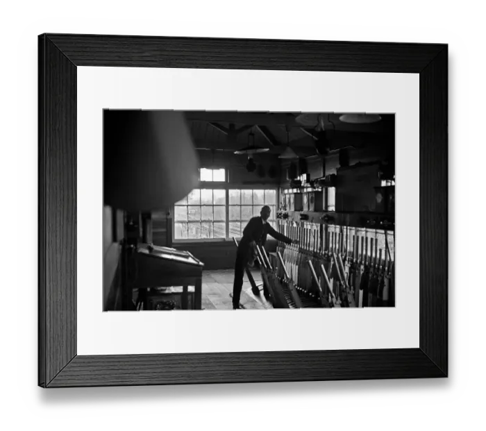 Framed Print : Signalman working in an unknown signal box on the Woking to Waterloo line. November 1938 Framed Print : Signalman working in an unknown signal box on the Woking to Waterloo line. November 1938