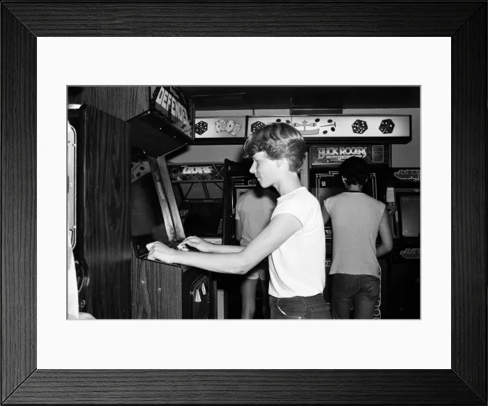 Framed Print : Young people playing video games in an amusement arcade in London. 13th July 1983 Framed Print : Young people playing video games in an amusement arcade in London. 13th July 1983