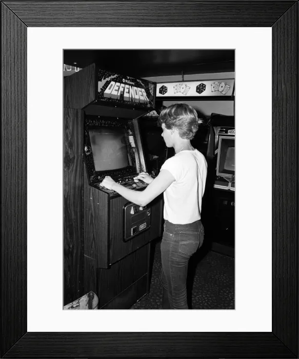 Framed Print : Young people playing video games in an amusement arcade in London. 13th July 1983 Framed Print : Young people playing video games in an amusement arcade in London. 13th July 1983