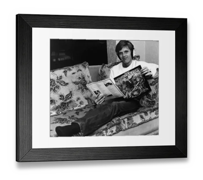 Framed Print : Gordon McQueen, Manchester United defender, with a copy of Elton Johns album Framed Print : Gordon McQueen, Manchester United defender, with a copy of Elton Johns album