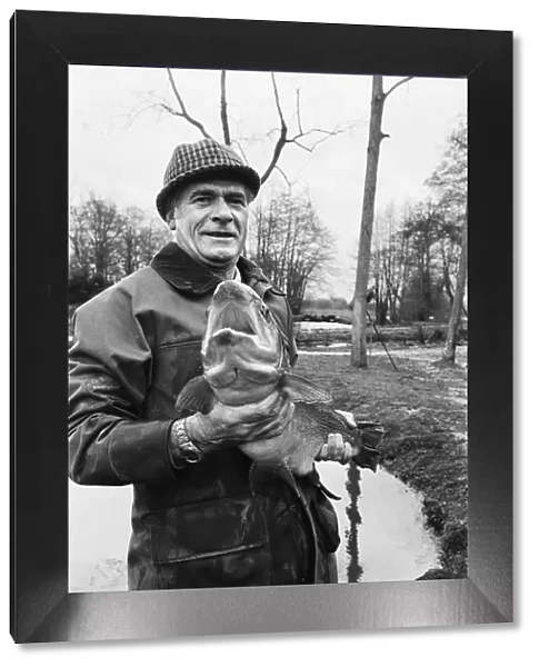 Mr Sam Holland (52) owner of Avington Trout Fishery, with a 3 year old Avington Strain
