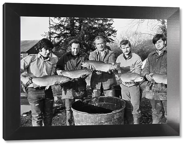 Sam Holland (centre) and trout famers holding trout. 13th February 1976