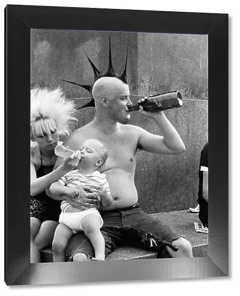 Punk rocker Jock and his young son William enjoying the warm weather in Trafalgar Square