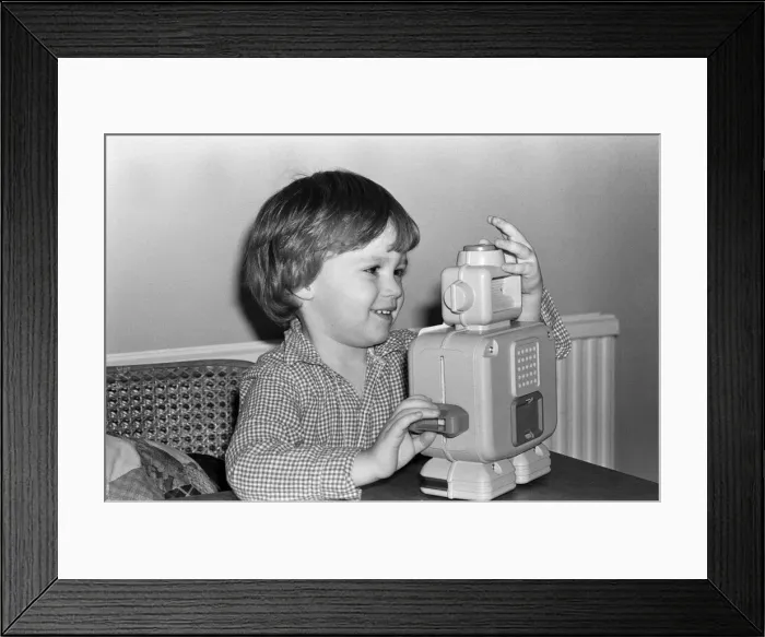 Framed Print : Electronic childrens toys. Pictured, 3 year old Matthew with an electronic robot Framed Print : Electronic childrens toys. Pictured, 3 year old Matthew with an electronic robot