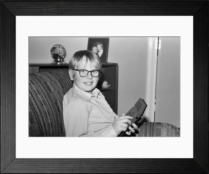 Framed Print : Electronic childrens toys. Pictured, 12 year old Mark with the Merlin Electronic Framed Print : Electronic childrens toys. Pictured, 12 year old Mark with the Merlin Electronic