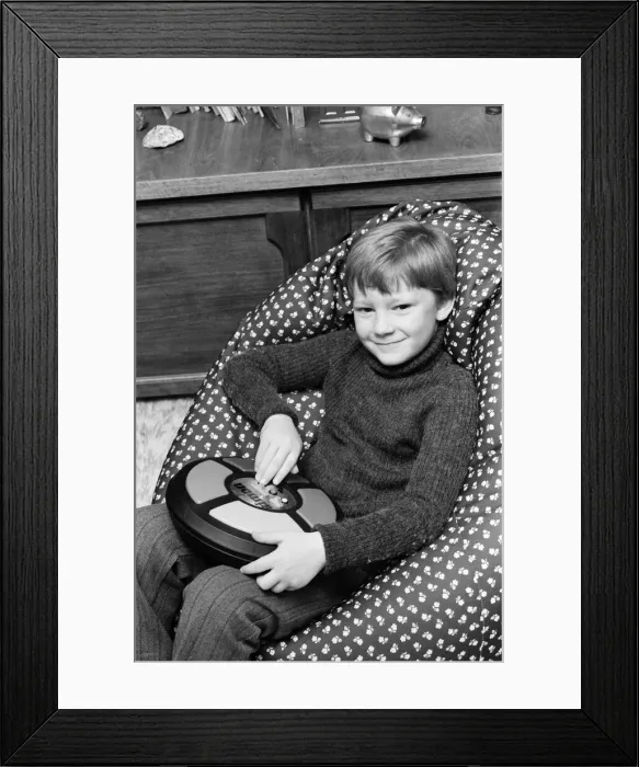 Framed Print : Electronic childrens toys. Pictured, 7 year old Simon with the Simon electronic Framed Print : Electronic childrens toys. Pictured, 7 year old Simon with the Simon electronic