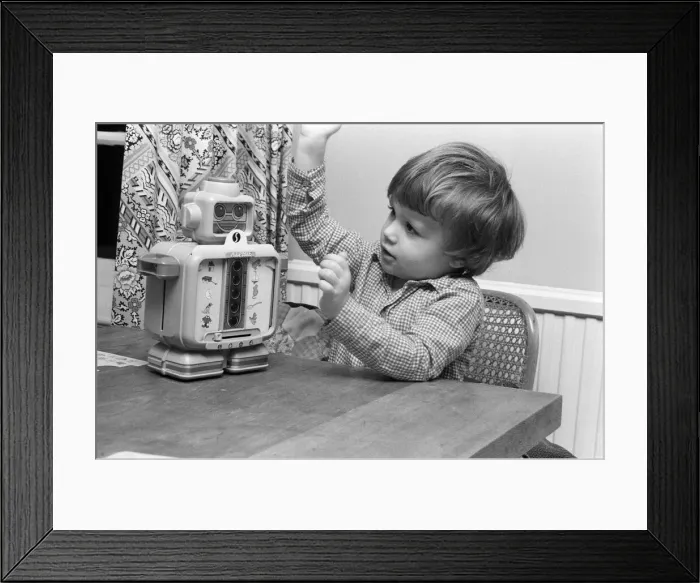 Framed Print : Electronic childrens toys. Pictured, 3 year old Matthew with an electronic robot Framed Print : Electronic childrens toys. Pictured, 3 year old Matthew with an electronic robot